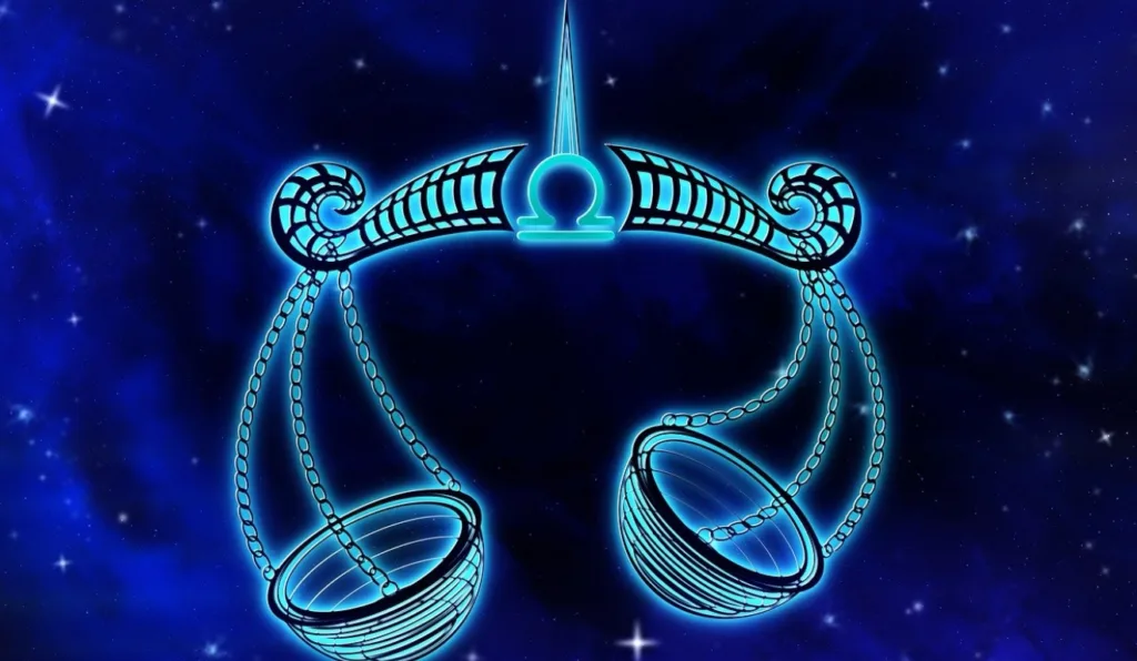 A imagem apresenta uma balança, que representa o signo de Libra.