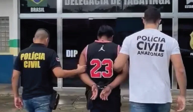 Imagem do suspeito sendo levado para a delegacia.