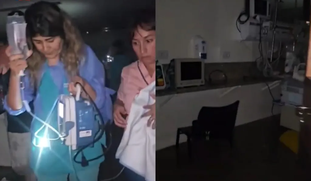 Enfermeiras retirando bebê de hospital inundado.