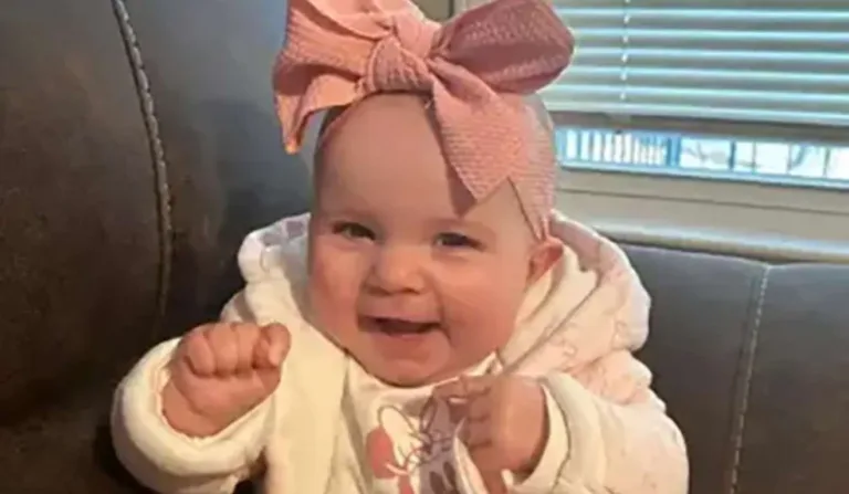 bebê sorrindo com laço na cabeça