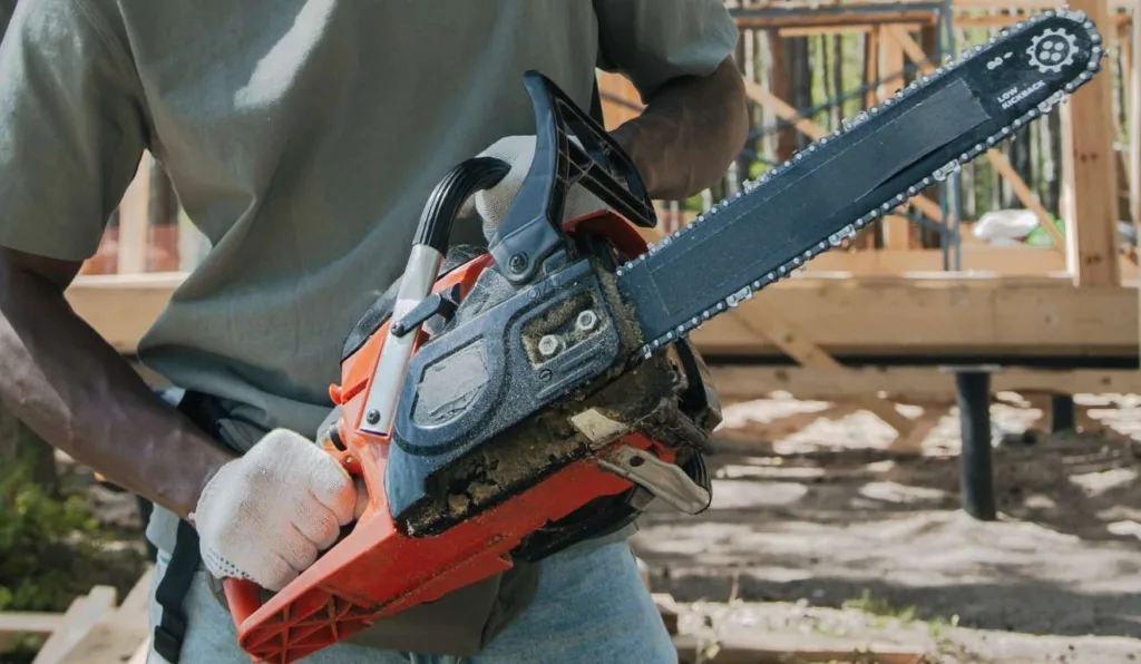 homem segurando uma motosserra