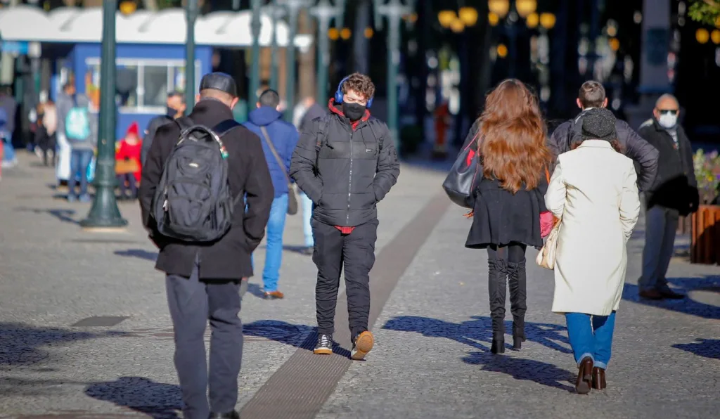 pessoas andando no frio para ilustrar previsão do tempo em Curitiba