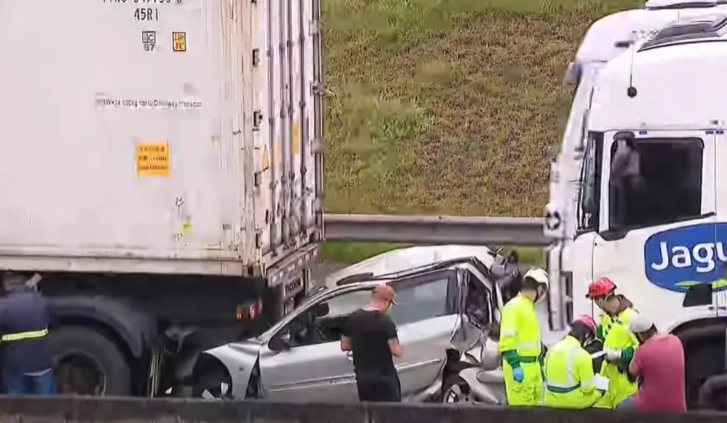 carro esmagado pelos dois caminhões