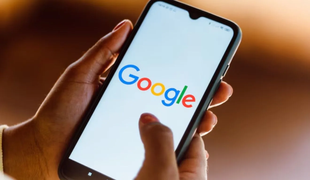 mão segurando celular logado no google