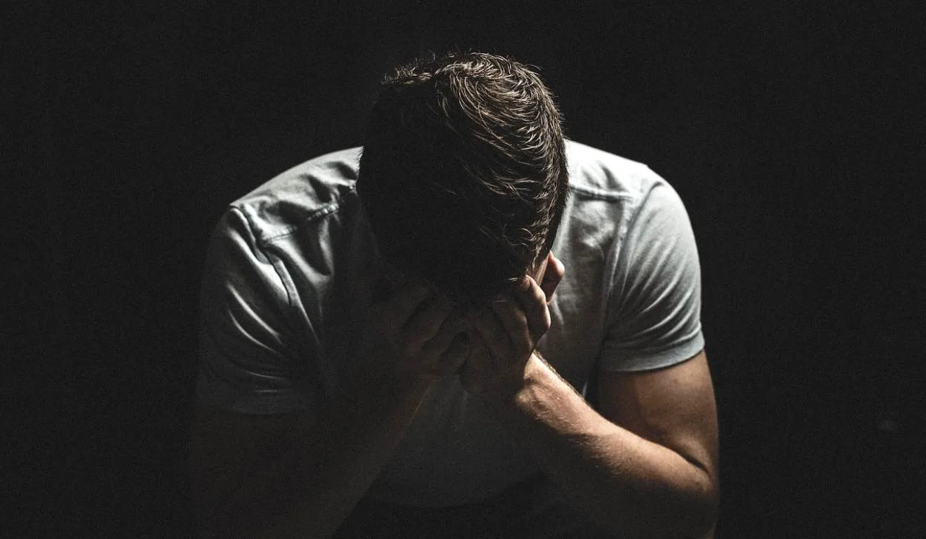 Homem de cabeça baixa