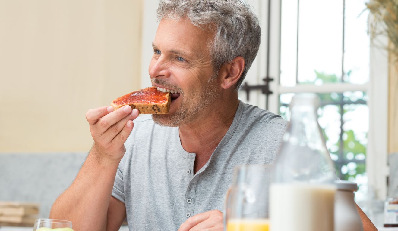 Homem comendo torrada com geléia