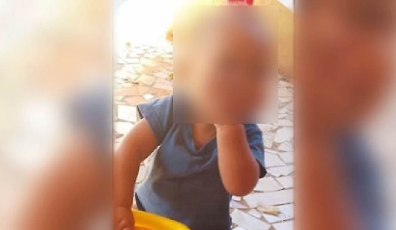bebê que morreu afogado em balde de água em foto com mão na boca