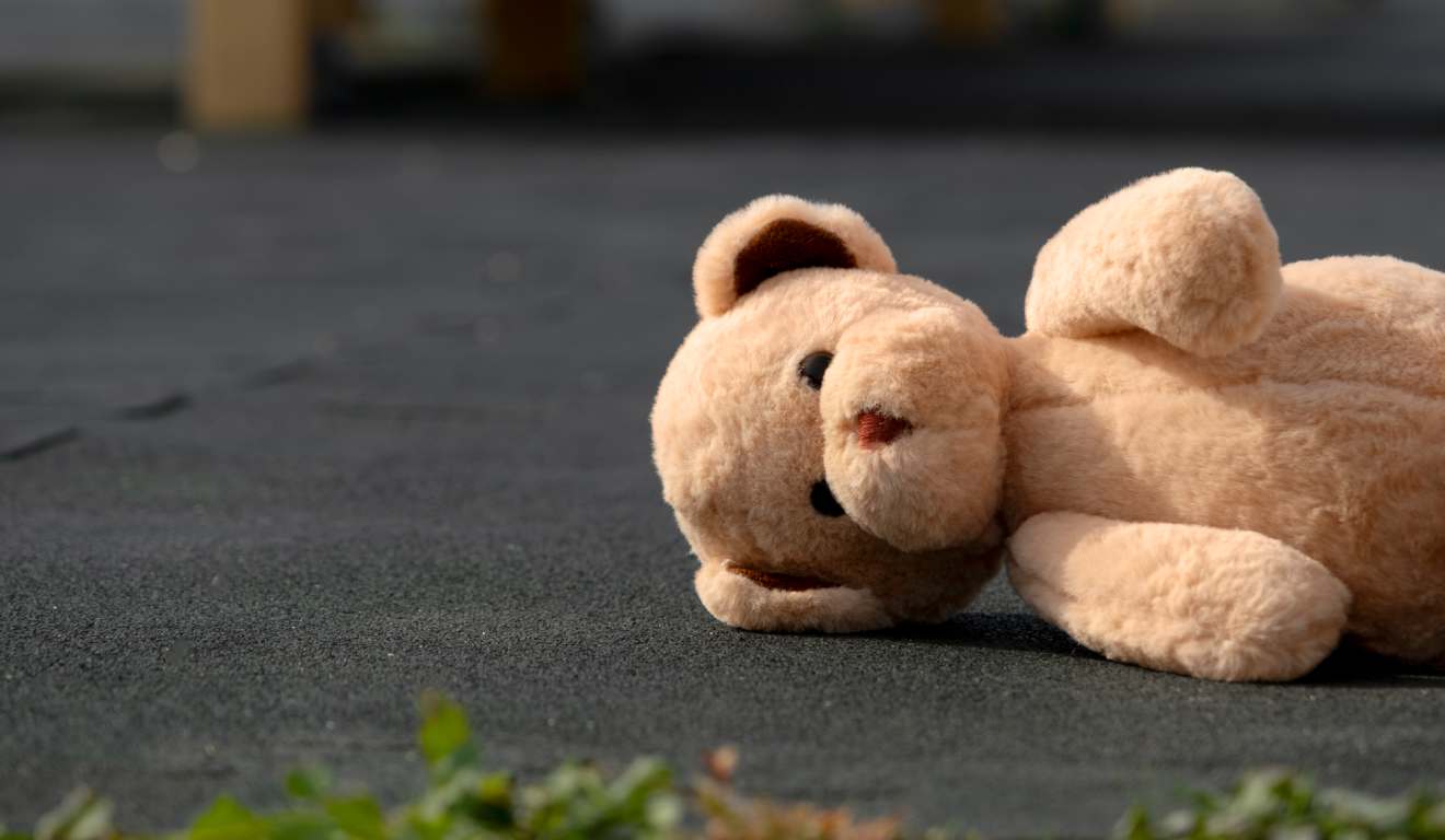 urso de pelúcia caído no chão para representar criança abusada dentro de igreja