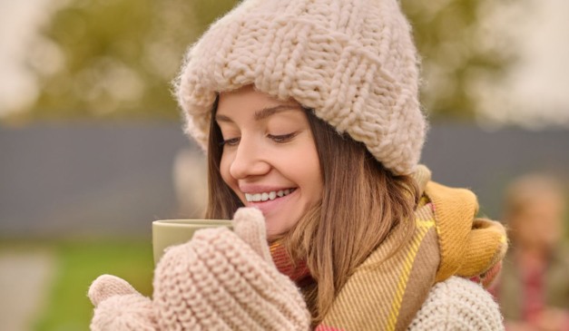 Mulher tomando chá em xícara.