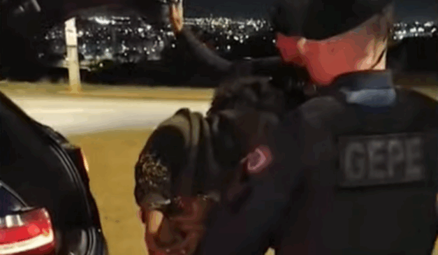 Policiais prendendo homem.