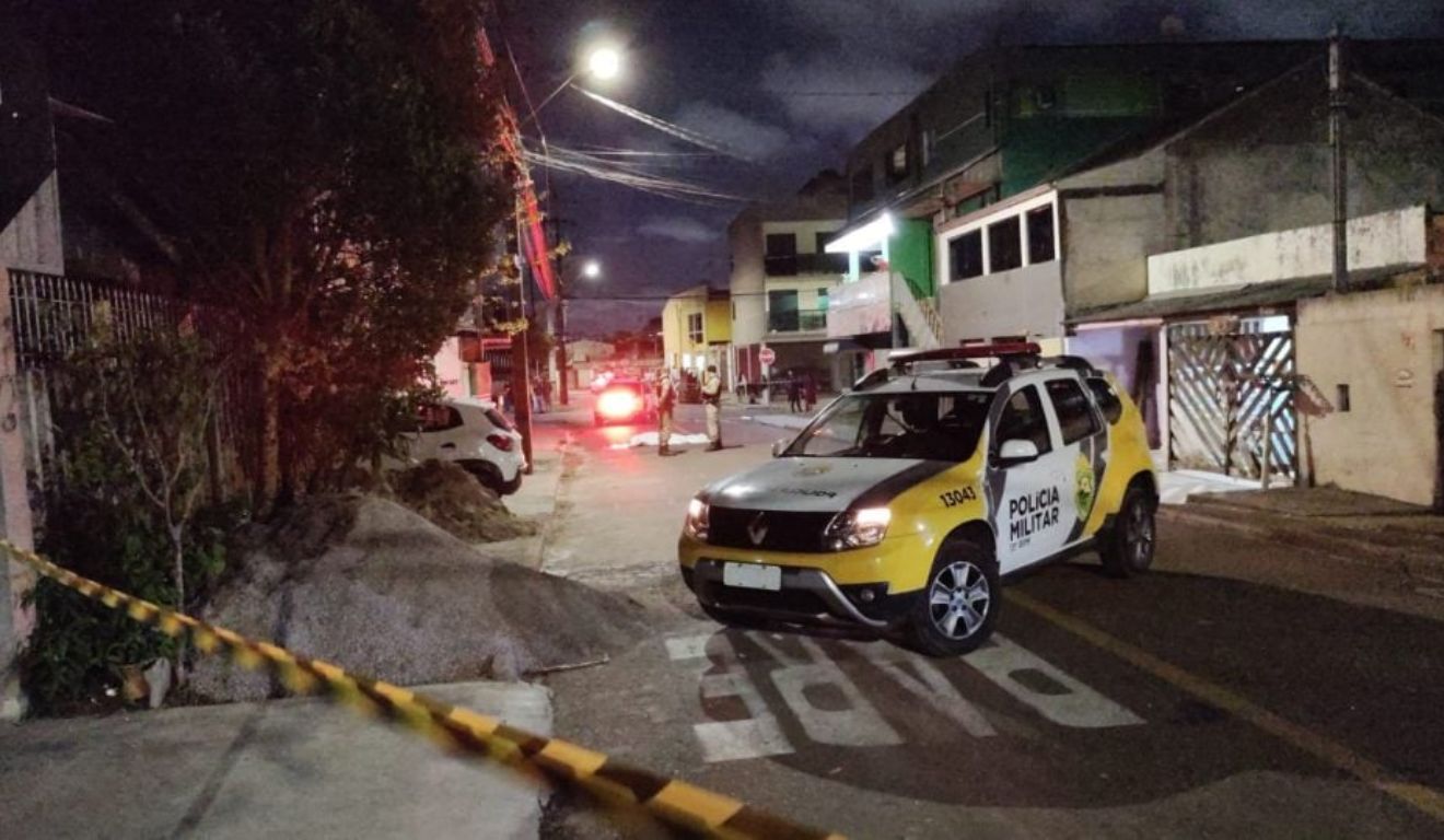 Viaturas da Polícia Militar no local em que dois homens foram emboscados, após visitarem familiares, em Curitiba