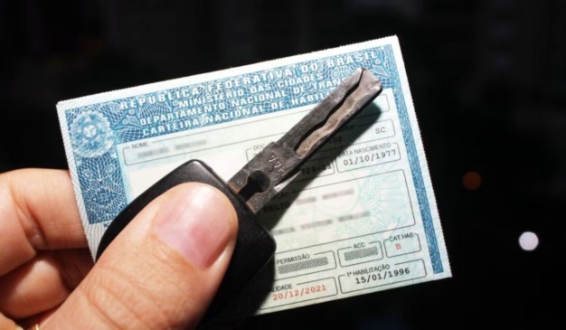 carteira de habilitação com chave de veículo em cima