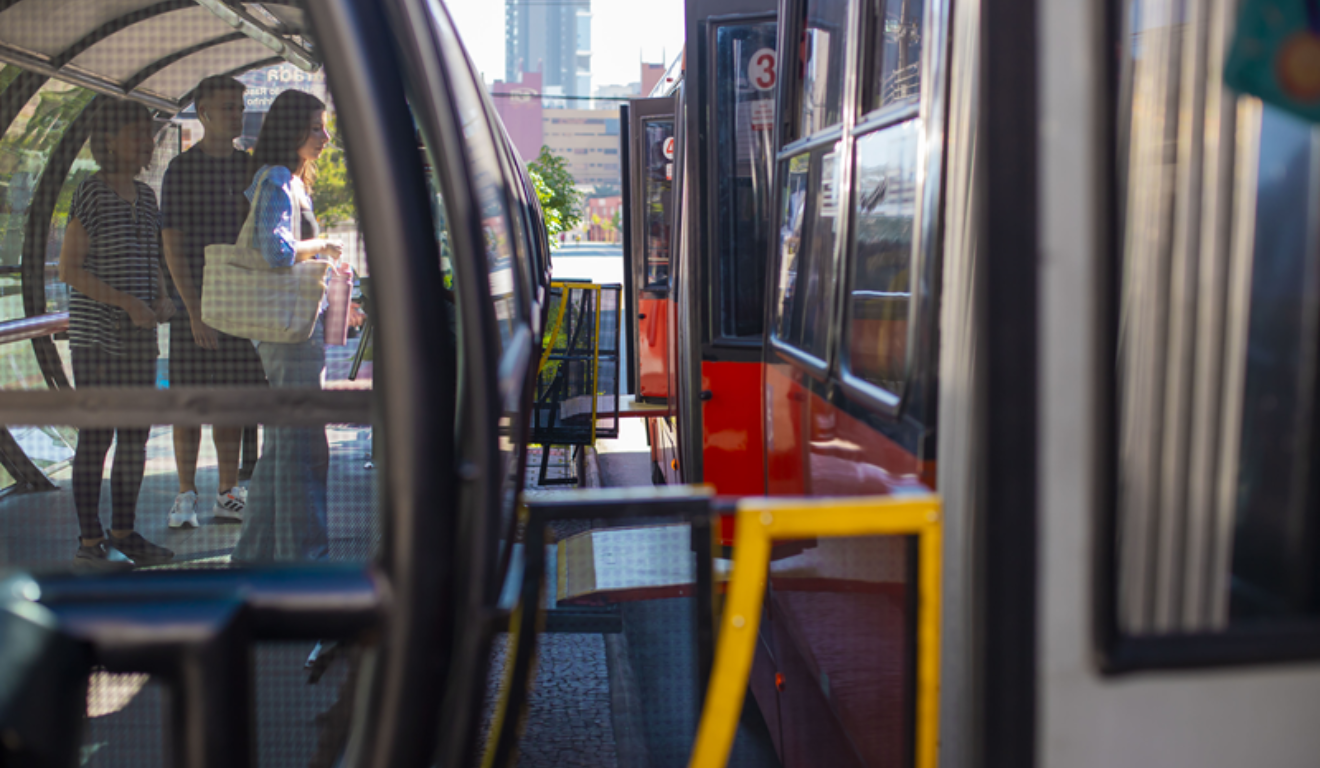 Neste domingo, Curitiba terá reforço de linhas de ônibus para candidatos que realizarão provas do Enam e da Universidade Positivo. Na imagem, vemos um ônibus biarticulado de Curitiba, com as portas abertas em uma estação-tubo.