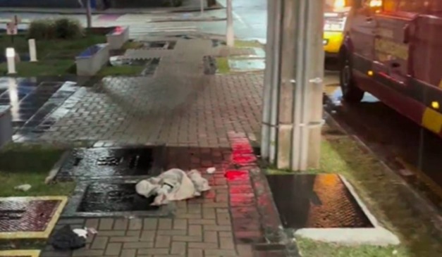 Local com roupas no chão onde homem foi entubado na calçada