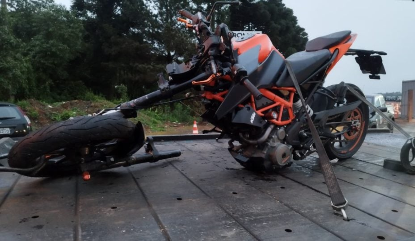 Um motociclista ficou gravemente ferido após colidir com caminhão em Curitiba. Na imagem, vemos a moto em um caminhão de reboque após o acidente.