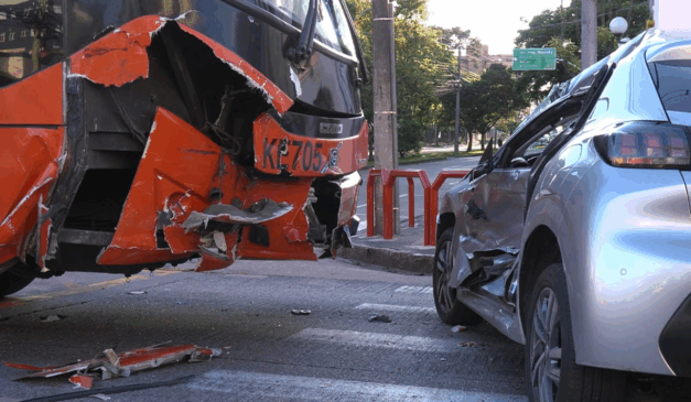 Um motorista fez uma conversão proibida e teve seu carro arrastado em Curitiba. Na imagem, vemos uma foto que mostra tanto a frente do ônibus quanto a lateral do carro danificadas.