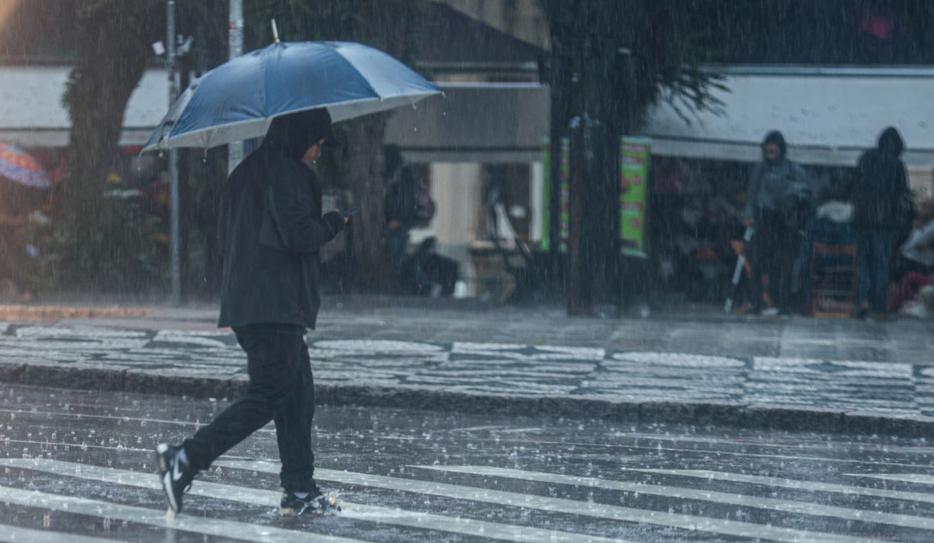 pessoa andando na chuva para ilustrar o fim do ciclone no paraná