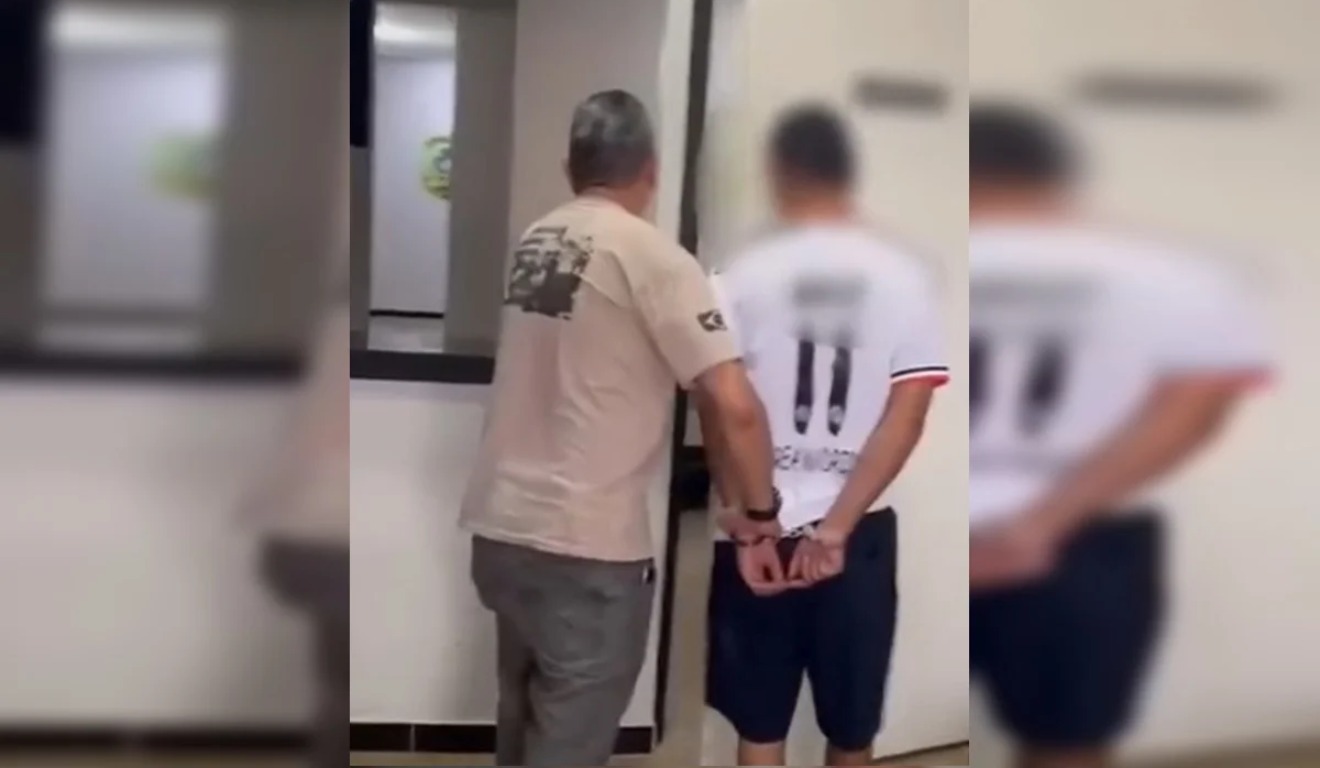 Suspeito sendo preso.